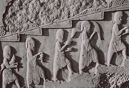 antique relief with people climbing stairs